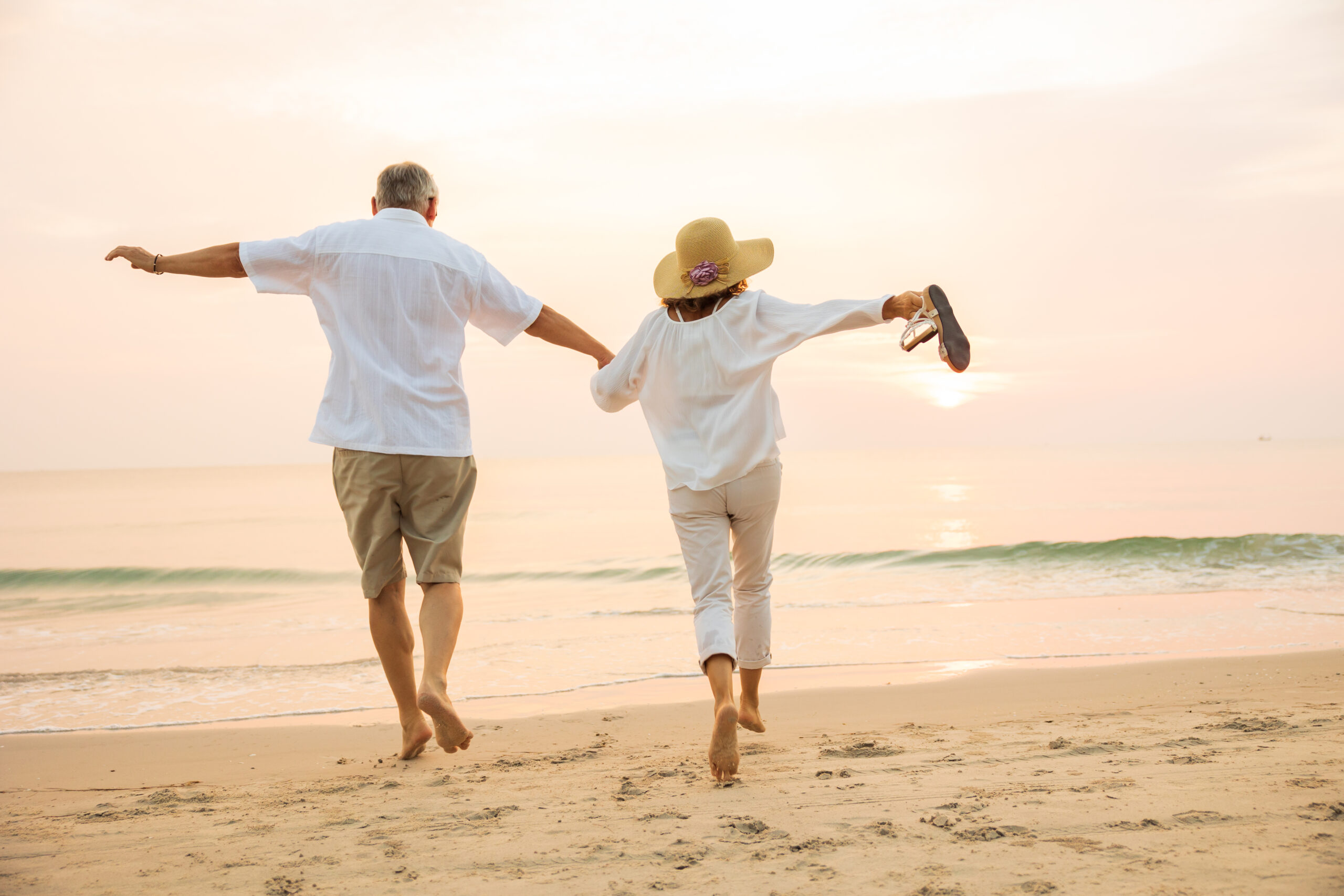 Active senior couple walking on the beach